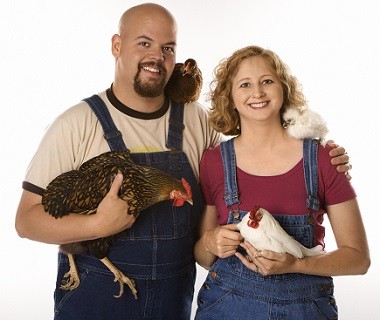Woman and man with pet chickens.